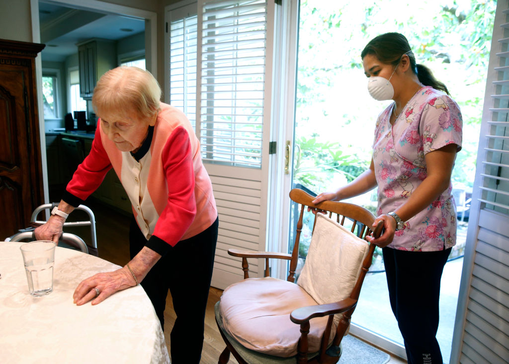 Placing A Higher Value On Direct Care Workers Commonwealth Fund   Home Health Aide Helps Patient In Their Home 